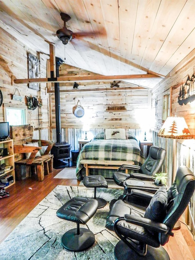 N12366 Chisum Trl, Athelstane, WI 54104 - bedroom with wood walls, a wood stove, vaulted ceiling, wooden ceiling, and wood finished floors