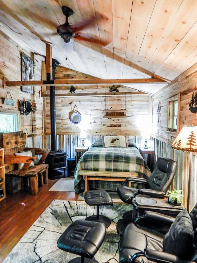 N12366 Chisum Trl, Athelstane, WI 54104 - bedroom with wooden walls, wooden ceiling, vaulted ceiling, a wood stove, and wood finished floors