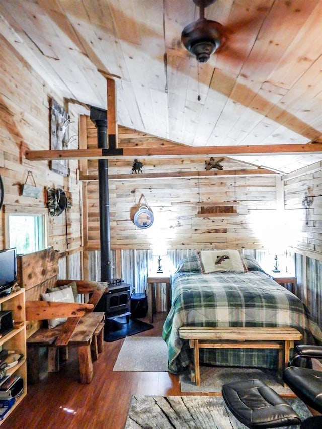 N12366 Chisum Trl, Athelstane, WI 54104 - bedroom with wooden walls, lofted ceiling, a wood stove, wood ceiling, and hardwood / wood-style flooring