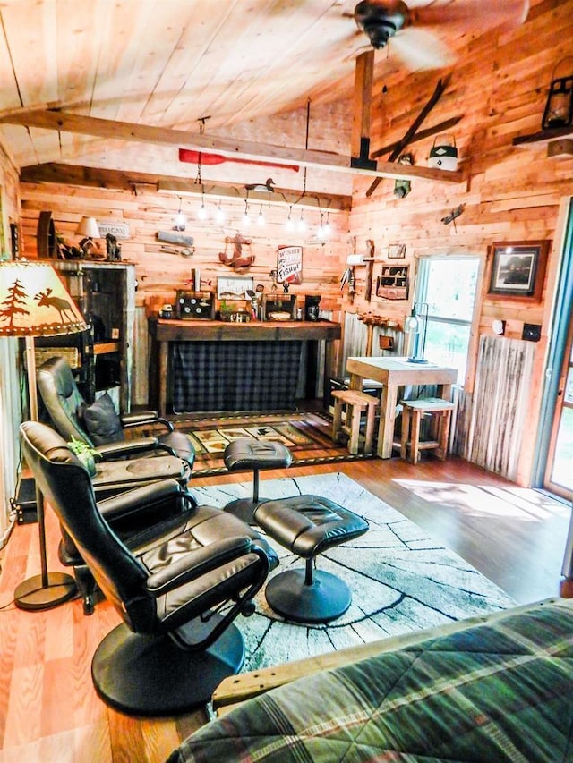 N12366 Chisum Trl, Athelstane, WI 54104 - living area featuring wood walls, lofted ceiling, wood finished floors, healthy amount of natural light, and wood ceiling