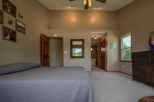 3637 121st Pl, Pleasant Prairie, WI 53158 - bedroom featuring multiple windows, light carpet, a towering ceiling, connected bathroom, and ceiling fan