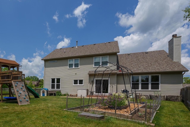 3637 121st Pl, Pleasant Prairie, WI 53158 - back of property with a vegetable garden, a playground, a chimney, and a shingled roof