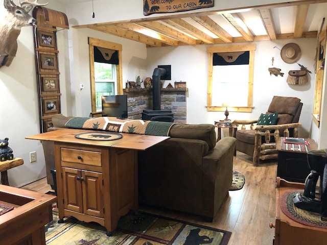 W15036 Poachers Run Ln, Athelstane, WI 54101 - living area featuring a wood stove, light wood-type flooring, and beamed ceiling