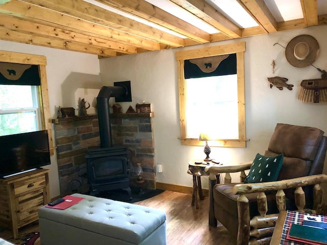 W15036 Poachers Run Ln, Athelstane, WI 54101 - sitting room with a wood stove, wood finished floors, and beam ceiling