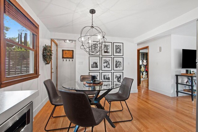 625 N Winnebago St, De Pere, WI 54115 - dining area featuring a chandelier and light wood-type flooring