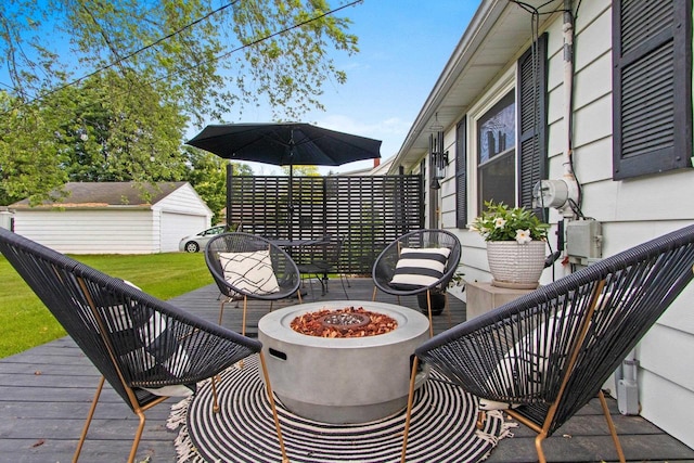 625 N Winnebago St, De Pere, WI 54115 - view of patio / terrace with an outdoor fire pit, a deck, and an outbuilding