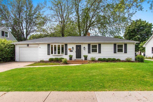 625 N Winnebago St, De Pere, WI 54115 - single story home with a garage, driveway, a front yard, and a chimney