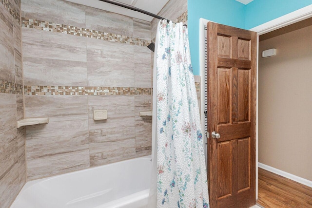 8383 N 50th St, Brown Deer, WI 53223 - full bathroom featuring shower / bath combo with shower curtain and wood finished floors