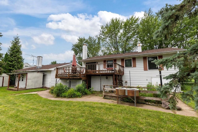 6610 Kelly Ln, Winneconne, WI 54986 - back of house with a wooden deck, a storage shed, and a lawn