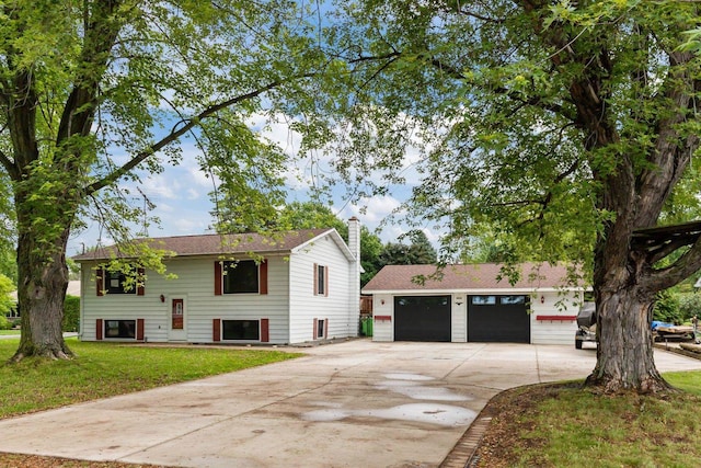 6610 Kelly Ln, Winneconne, WI 54986 - view of front of home with driveway, a chimney, a front lawn, and a garage