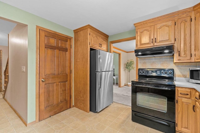2939 W Roselawn Dr, Appleton, WI 54914 - kitchen featuring appliances with stainless steel finishes, under cabinet range hood, light countertops, decorative backsplash, and light tile patterned floors