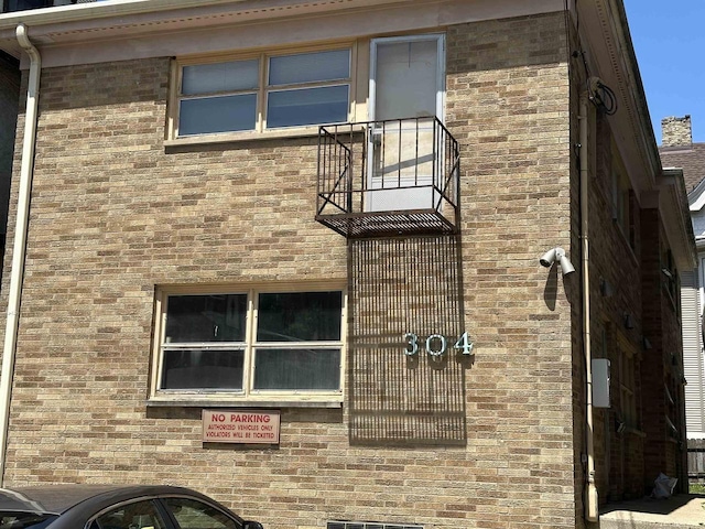 304 W Wilson St, Madison, WI 53703 - view of property exterior with brick siding and a balcony