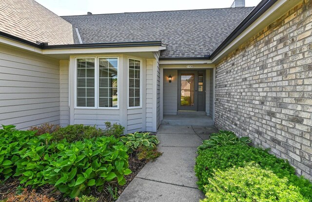 540 Mc Aurther Ln Unit B, Brookfield, WI 53045 - doorway to property with a shingled roof and a chimney