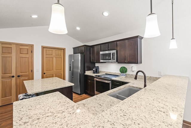 1734 Arthurs Pass, Oconomowoc, WI 53066 - kitchen with appliances with stainless steel finishes, lofted ceiling, light wood-style flooring, dark brown cabinetry, and light stone counters
