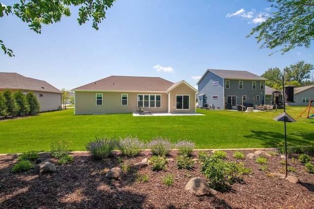 1734 Arthurs Pass, Oconomowoc, WI 53066 - back of house featuring a patio area and a lawn