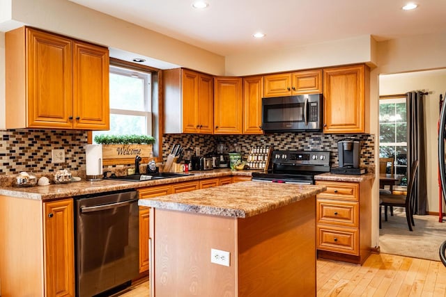 1615 Palamino Dr, Racine, WI 53402 - kitchen with stainless steel appliances, light wood-style flooring, recessed lighting, a center island, and light countertops