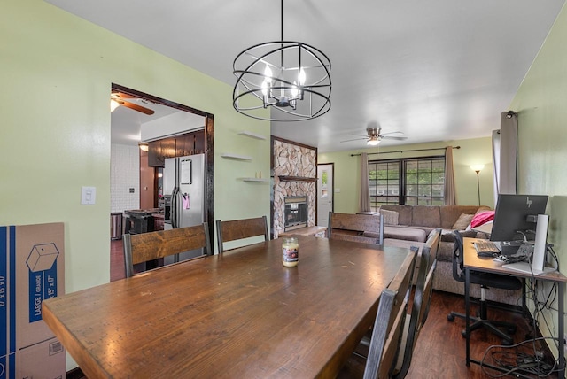 248 E Norport Dr, Port Washington, WI 53074 - dining area with ceiling fan, a fireplace, a chandelier, and wood finished floors