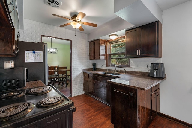 248 E Norport Dr, Port Washington, WI 53074 - kitchen featuring black appliances, ceiling fan, dark wood finished floors, dark brown cabinets, and a chandelier