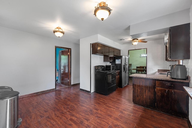 248 E Norport Dr, Port Washington, WI 53074 - kitchen featuring black range, stainless steel fridge, dark brown cabinetry, dark wood-type flooring, and ceiling fan