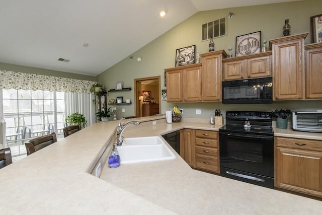9245 S 54th St, Franklin, WI 53132 - kitchen featuring black appliances, vaulted ceiling, light countertops, and a peninsula
