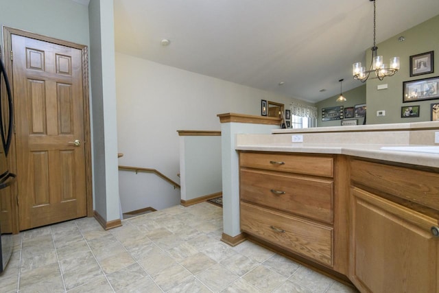 9245 S 54th St, Franklin, WI 53132 - kitchen with vaulted ceiling, a chandelier, light countertops, brown cabinets, and decorative light fixtures