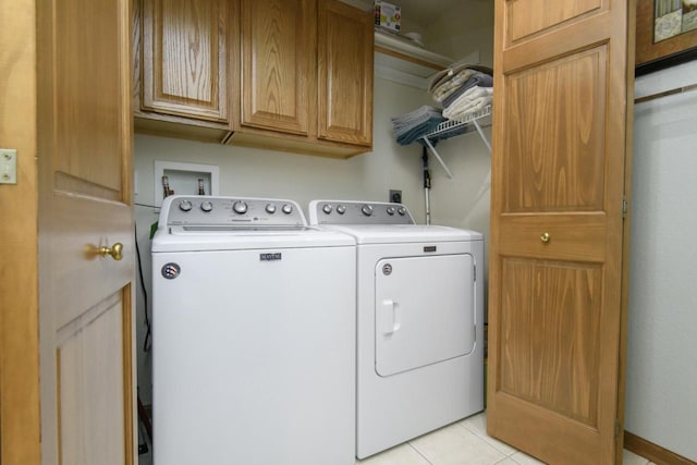 9245 S 54th St, Franklin, WI 53132 - laundry area featuring separate washer and dryer, cabinet space, and light tile patterned floors