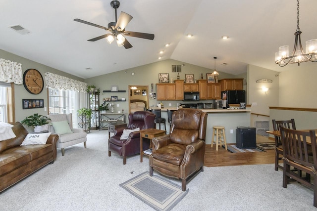 9245 S 54th St, Franklin, WI 53132 - living room with light carpet, vaulted ceiling, a chandelier, and ceiling fan