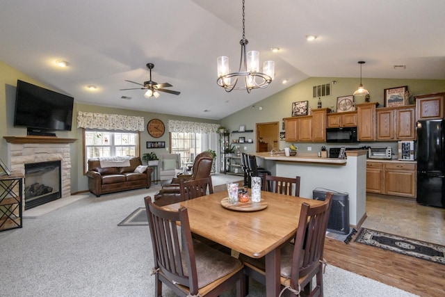 9245 S 54th St, Franklin, WI 53132 - dining space featuring lofted ceiling, a ceiling fan, a fireplace, a chandelier, and light wood-style floors