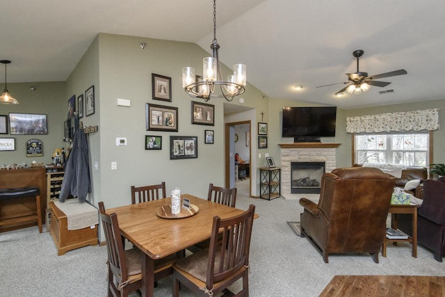 9245 S 54th St, Franklin, WI 53132 - dining room with a ceiling fan, a fireplace, a chandelier, lofted ceiling, and light carpet