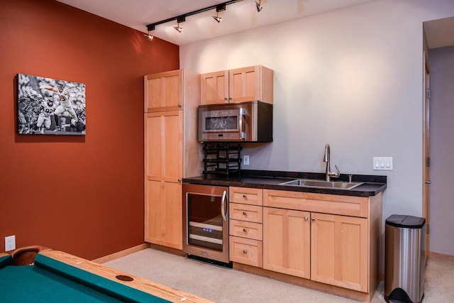 6846 Frank Lloyd Wright Ave, Middleton, WI 53562 - kitchen featuring stainless steel microwave, light brown cabinetry, wine cooler, and light carpet