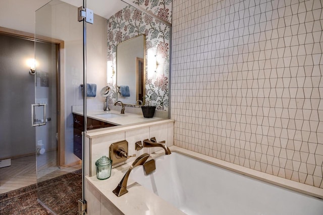 6846 Frank Lloyd Wright Ave, Middleton, WI 53562 - bathroom with a garden tub, vanity, and wallpapered walls
