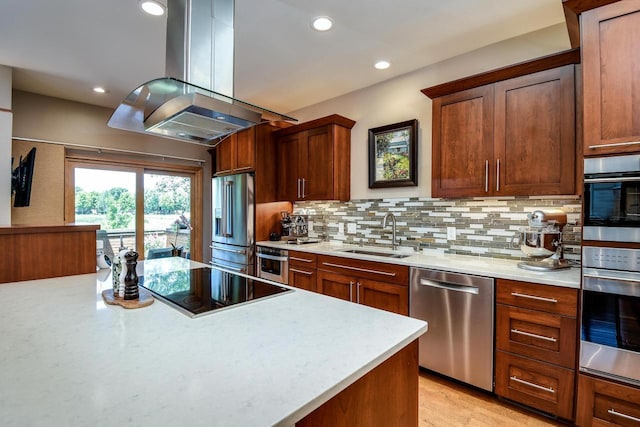 6846 Frank Lloyd Wright Ave, Middleton, WI 53562 - kitchen featuring appliances with stainless steel finishes, island exhaust hood, light countertops, backsplash, and recessed lighting
