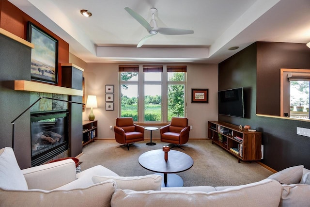 6846 Frank Lloyd Wright Ave, Middleton, WI 53562 - carpeted living room featuring plenty of natural light, ceiling fan, and a raised ceiling