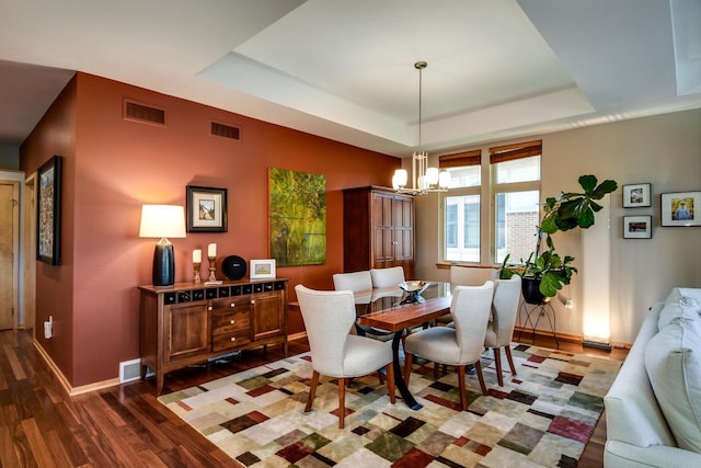 6846 Frank Lloyd Wright Ave, Middleton, WI 53562 - dining room with a tray ceiling, wood finished floors, and a chandelier