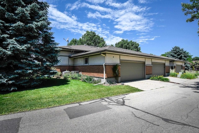 6846 Frank Lloyd Wright Ave, Middleton, WI 53562 - view of front of home featuring brick siding, an attached garage, concrete driveway, and a front lawn
