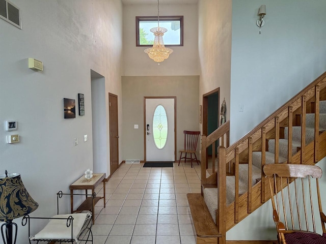 38630 Golf View Dr, Prairie Du Chien, WI 53821 - foyer featuring a high ceiling, a chandelier, stairs, and light tile patterned floors