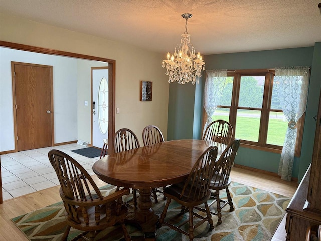 38630 Golf View Dr, Prairie Du Chien, WI 53821 - dining space with light wood finished floors, a chandelier, and a textured ceiling