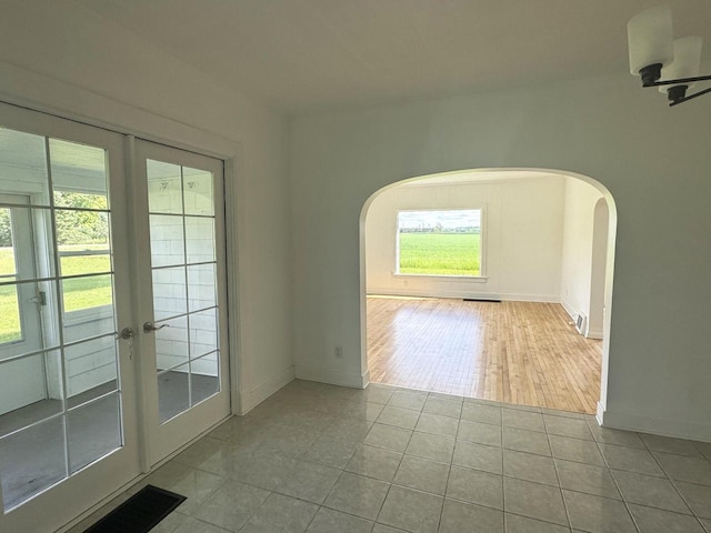 N5516 Polar Rd, Bryant, WI 54418 - tiled spare room with arched walkways and french doors