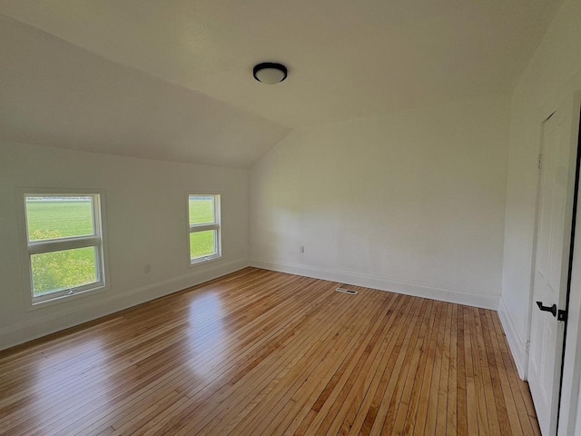N5516 Polar Rd, Bryant, WI 54418 - unfurnished room featuring light wood-style flooring and vaulted ceiling