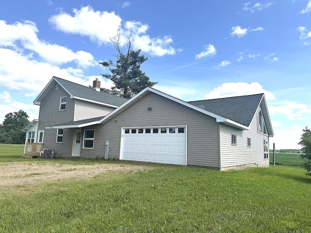 N5516 Polar Rd, Bryant, WI 54418 - back of property featuring a garage, a shingled roof, a yard, and driveway