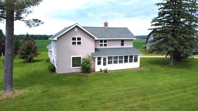 N5516 Polar Rd, Bryant, WI 54418 - back of house with roof with shingles, a chimney, a yard, and a sunroom