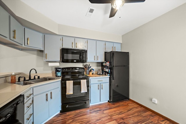 847 W Puetz Rd, Oak Creek, WI 53154 - kitchen featuring black appliances, a ceiling fan, dark wood-style floors, and light countertops