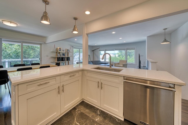 915 Mariane Ter, Lake Geneva, WI 53147 - kitchen with stainless steel dishwasher, light stone counters, decorative light fixtures, recessed lighting, and white cabinetry