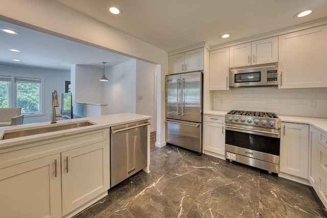 915 Mariane Ter, Lake Geneva, WI 53147 - kitchen featuring high end appliances, tasteful backsplash, dark marble finish flooring, light countertops, and recessed lighting