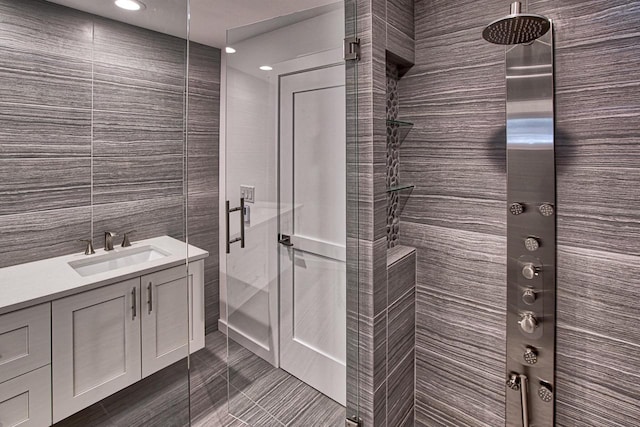 915 Mariane Ter, Lake Geneva, WI 53147 - bathroom featuring tile walls, a stall shower, vanity, and recessed lighting