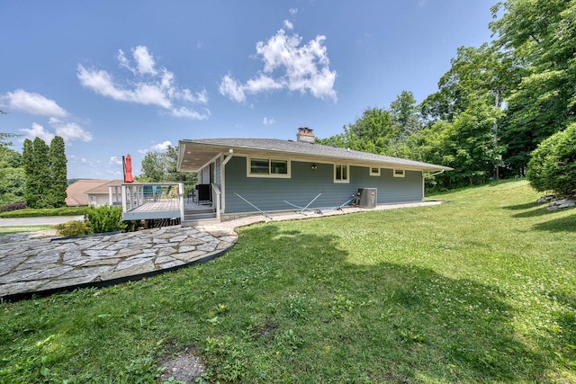 915 Mariane Ter, Lake Geneva, WI 53147 - back of house featuring a deck, a yard, and a chimney