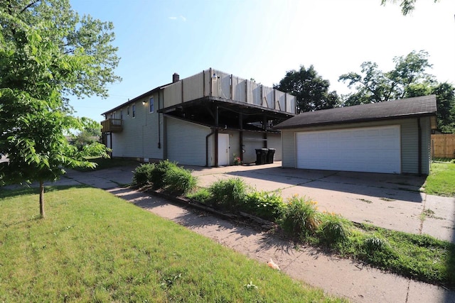 1503 St Lawrence Ave, Beloit, WI 53511 - rear view of property featuring a lawn and a garage
