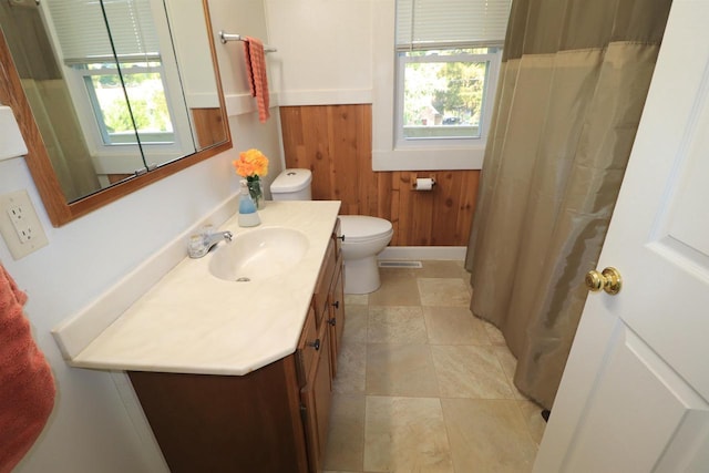 1503 St Lawrence Ave, Beloit, WI 53511 - bathroom featuring wooden walls, vanity, a wainscoted wall, and a shower with shower curtain
