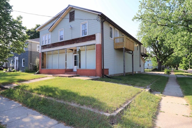 1503 St Lawrence Ave, Beloit, WI 53511 - view of front of home featuring a front lawn, brick siding, and a balcony