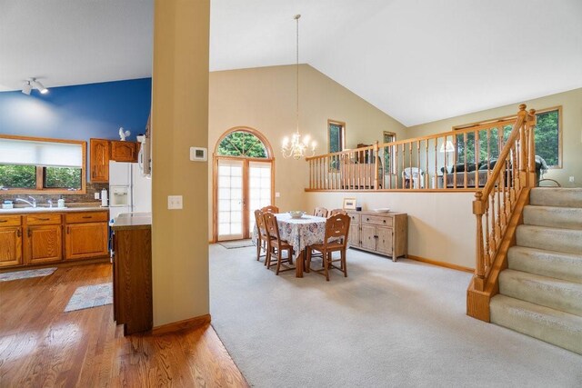 4129 Birch Crest Ln, Eau Claire, WI 54701 - dining space with a chandelier, high vaulted ceiling, plenty of natural light, and stairway
